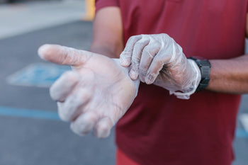 Man putting on disposable gloves